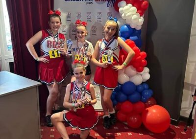 Kids with trophies at cheerleading dance competition