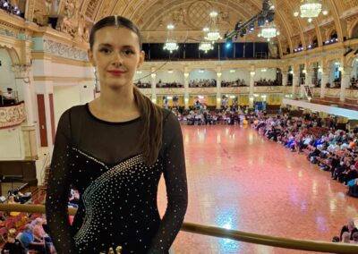 Lucy holding ballroom dance trophy
